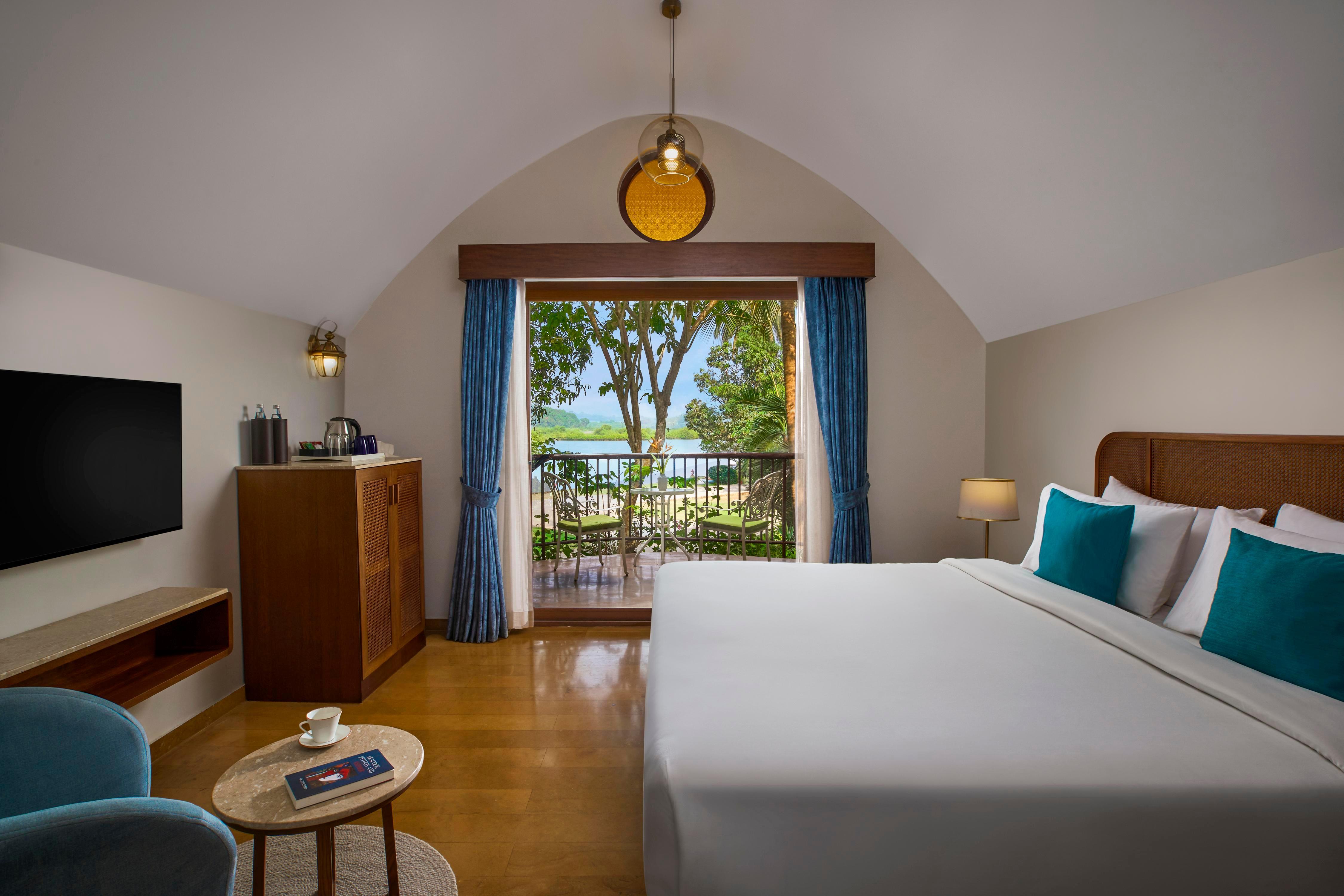 Mercure Goa Devaaya Resort Room Type - Villa Room with double bed, cosy sitout area with garden and scenic river views