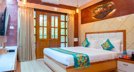 Treebo Green Village Resort With Pool Room Type - Deluxe Room with Balcony and Serene Water Stream View Treebo Green Village Resort With Pool Room Type - Deluxe Room with Balcony and Serene Water Stream View