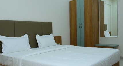 Amrutam Hotel and Guest House Room Type - Deluxe Room