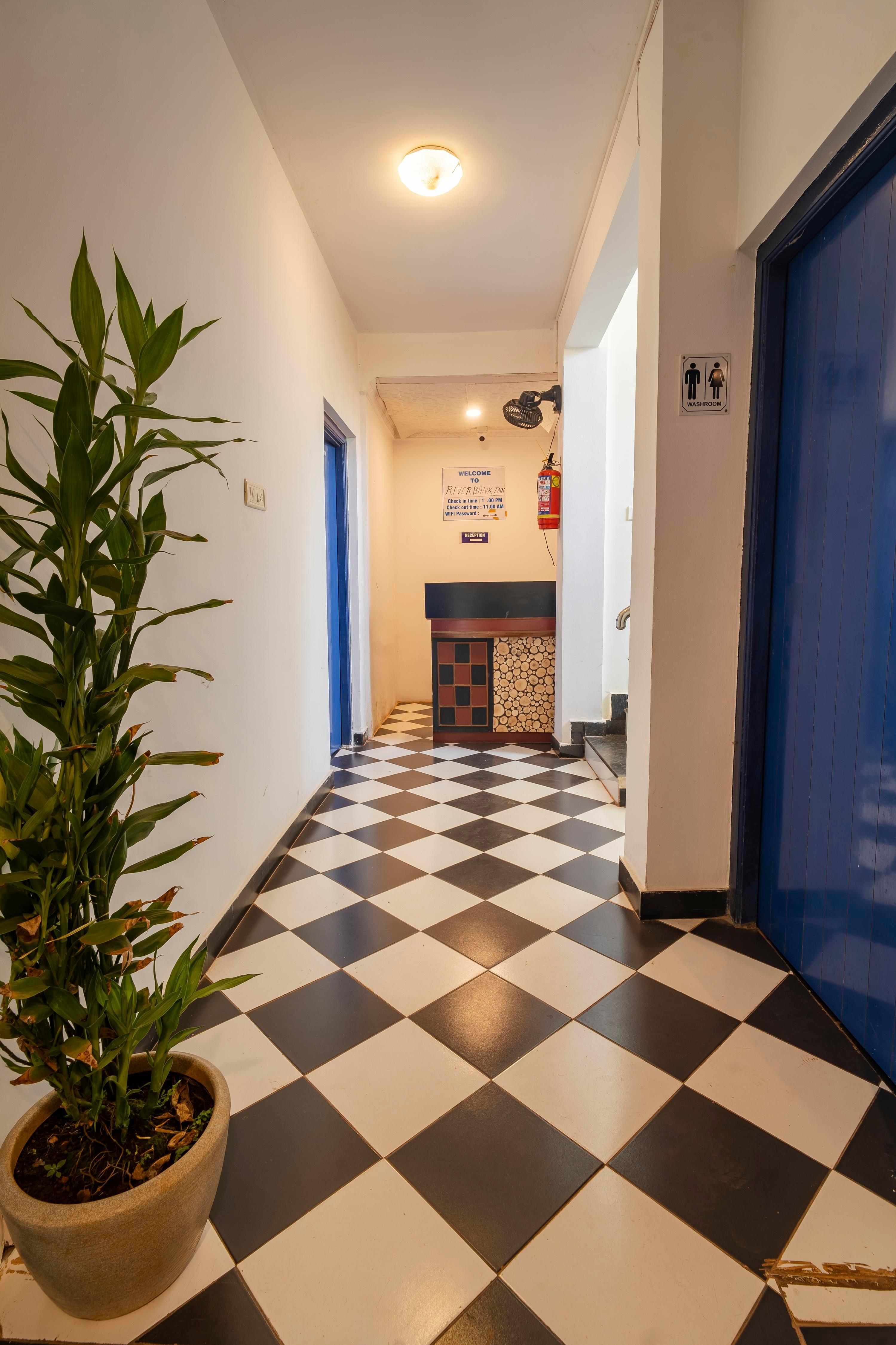 Riverbank Inn Luxury Rooms in Morjim - Tap to explore photos