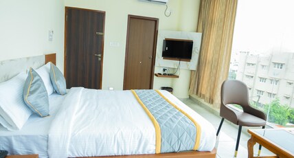 Sri Sai Castle IN Room Type - Deluxe Room with City View King Bed
