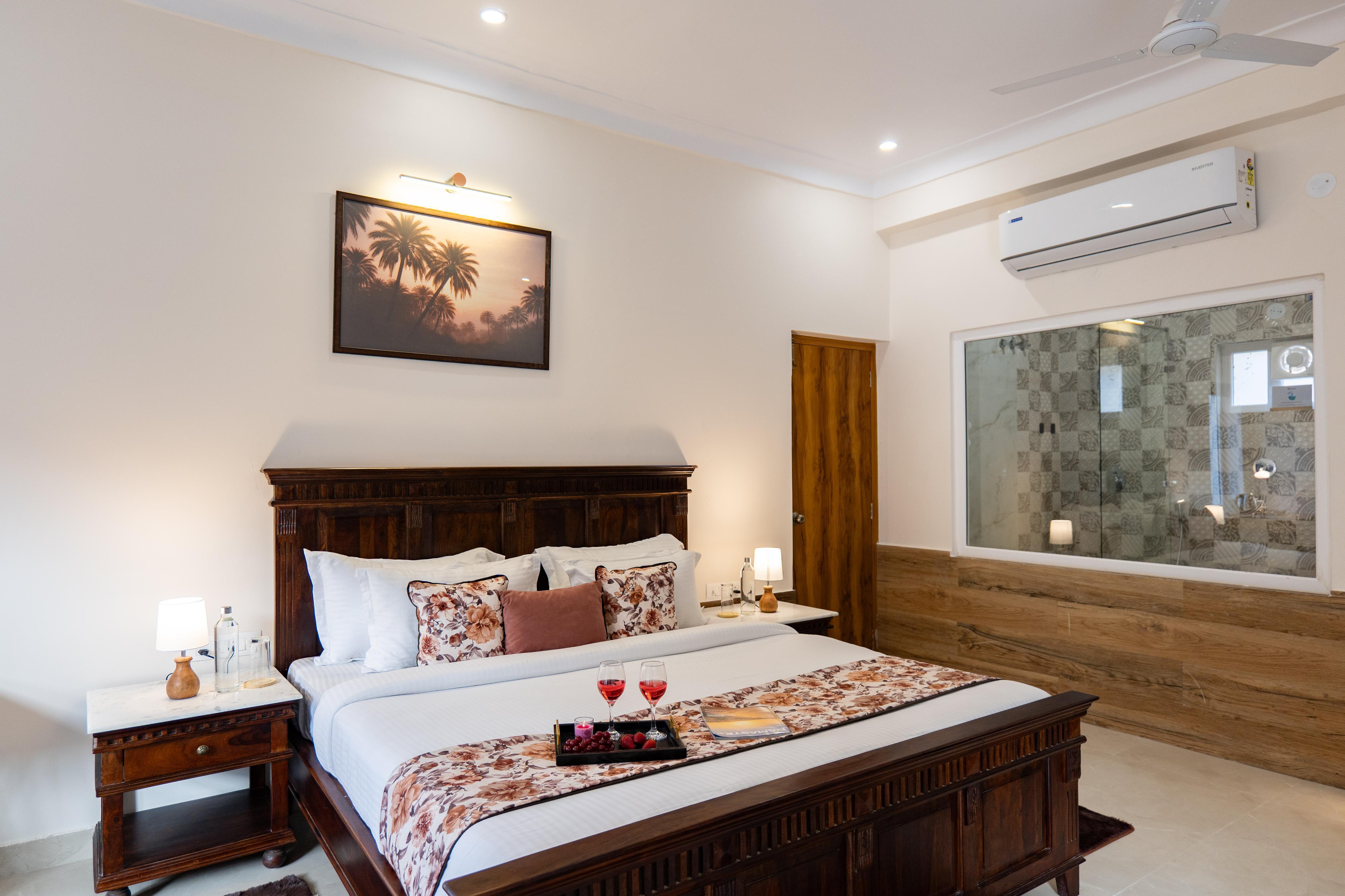 ELIVAAS Signature Mandovar 1 Room Suite with Common Pool & Garden - Tap to explore photos