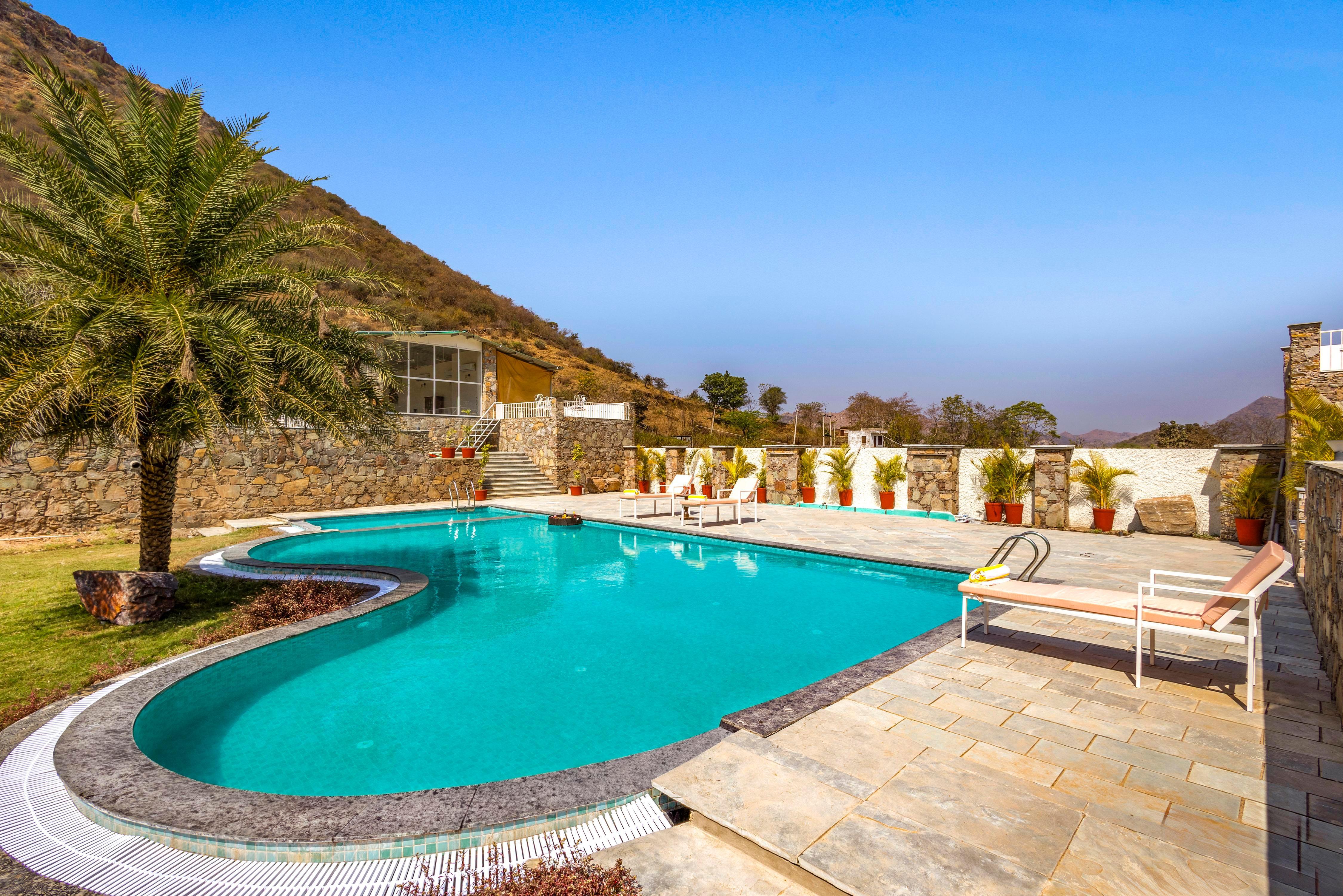ELIVAAS Signature Mandovar 1 Room Suite with Common Pool & Garden - Tap to explore photos