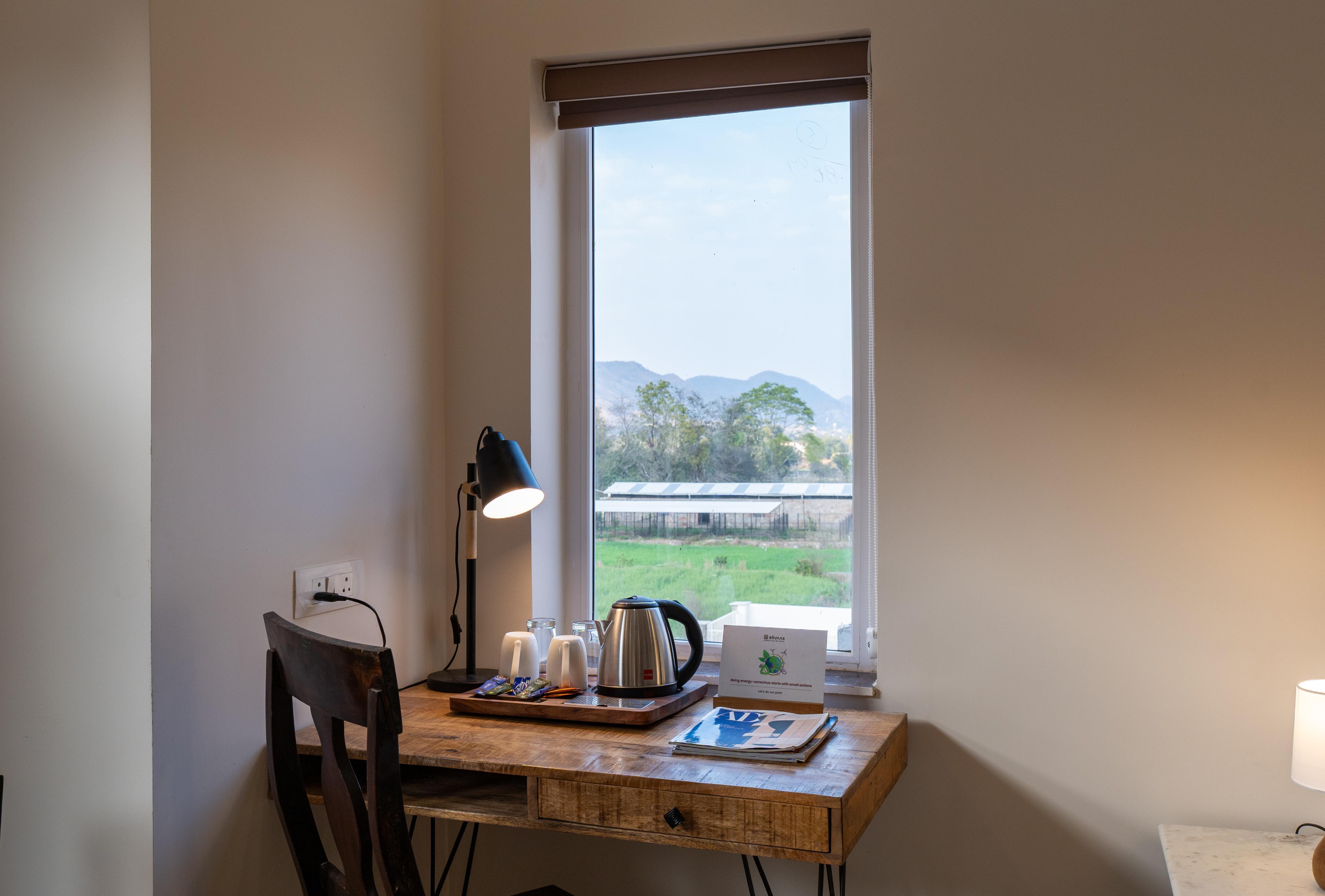 ELIVAAS Signature Mandovar 1 Room Suite with Common Pool & Garden - Tap to explore photos