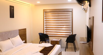 Elara Residency Room Type - Deluxe Room with Balcony and Garden View