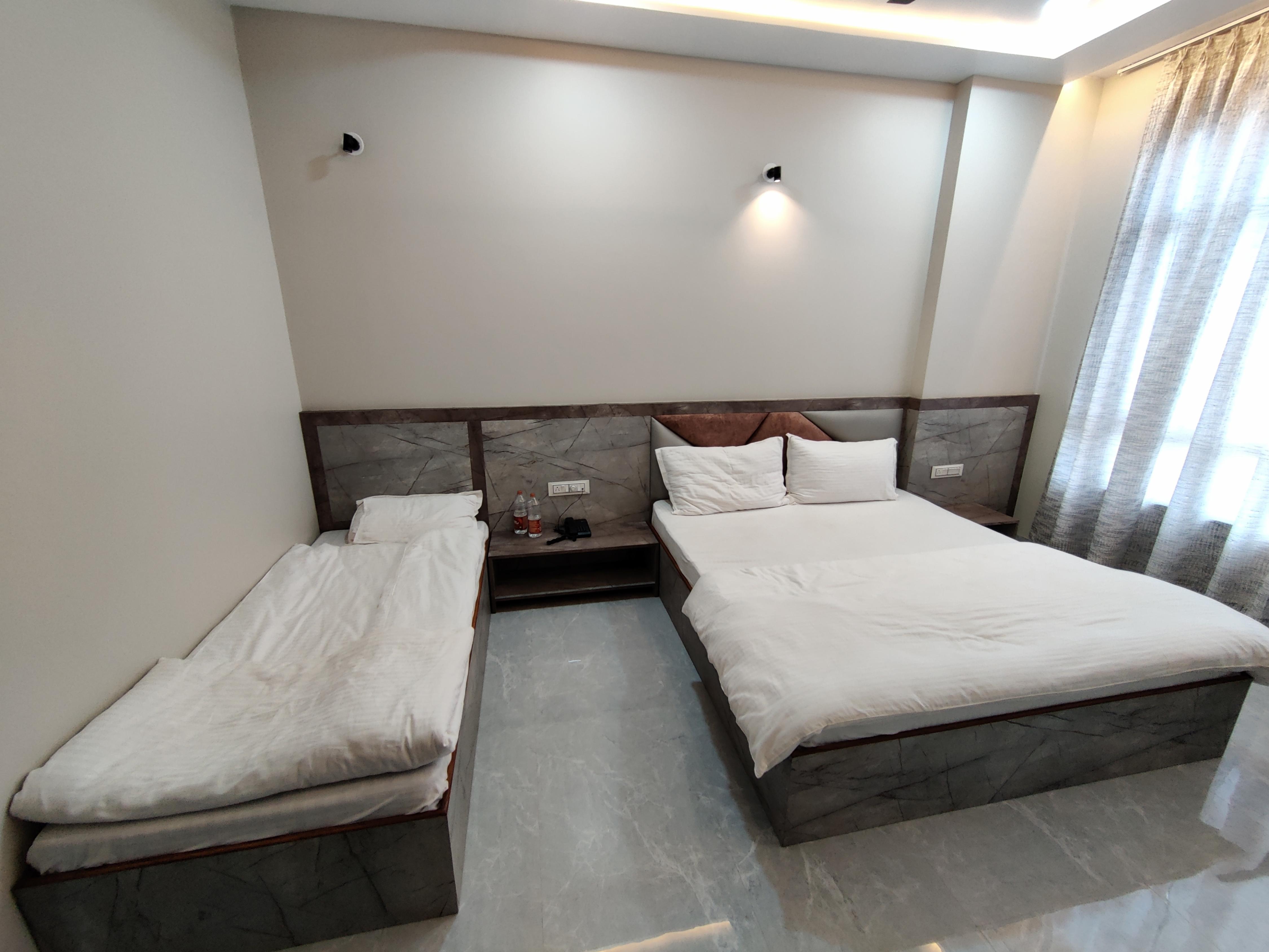 Hotel Ashirwad Room Type - Deluxe Triple Room ( 1 Double Bed + 1 Single Bed )