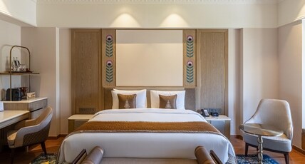 Wyndham Grand Udaipur Palace Room Type - Sajjangarh Palace view - A big bedroom with bath tub and view of Monsson palace Wyndham Grand Udaipur Palace Room Type - Sajjangarh Palace view - A big bedroom with bath tub and view of Monsson palace