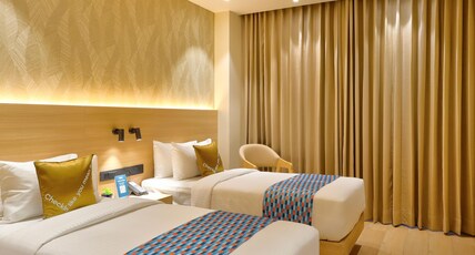 Palette Hotel & Convention Centre by CheckIn, Millennium City Gurugram Room Type - Premium Twin Room with Balcony